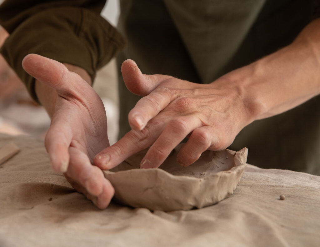 A person is making something out of clay.